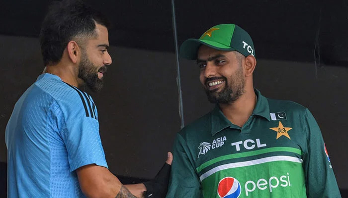 Pakistan skipper Babar Azam with Indias Virat Kohli. — AFP