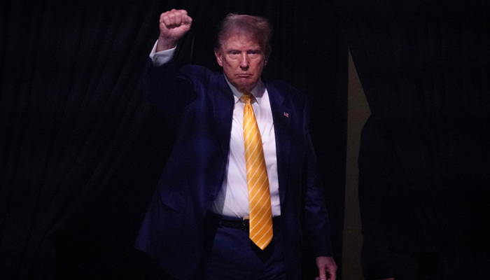 Former US President Donald Trump raises his fist as he walks off stage after participating in a town hall event at Dream City Church in Phoenix, Arizona, on June 6, 2024. — AFP