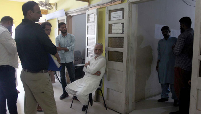 Social worker Sarim Burney is seen seated ahead of his hearing of case against him pertaining to human trafficking at the city court in Karachi on June 6, 2024. — PPI