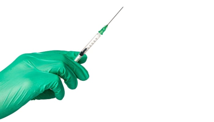 A medical professional is holding a syringe. —Pixabay/ File