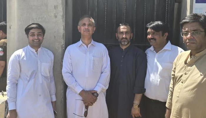 PTI Secretary-General Omar Ayub (centre left) standing outside court premises in Sargodha, on June 10, 2024. — X/@OmarAyubKhan