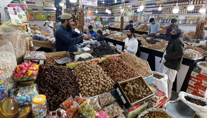 People buy dry fruits at a market in Karachi, Pakistan February 1, 2023. — Reuters