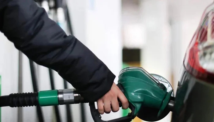 A person fills his cars tank at a fuel station in this undated file image. — AFP