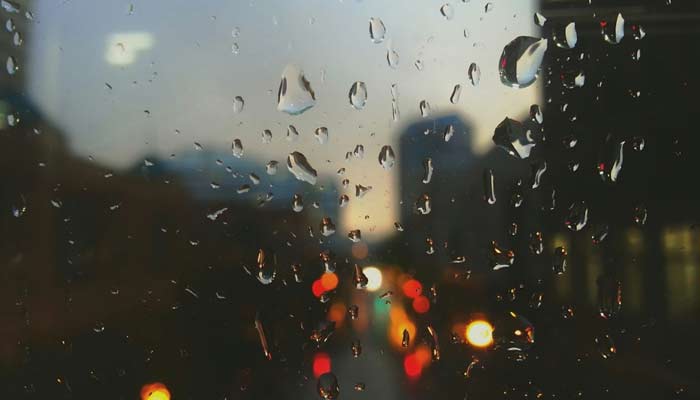 A representational image showing drizzle drops on a glass window. — Unsplash/File