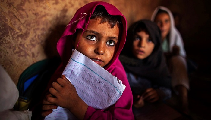 Girls attend lessons at a school in a slum on the outskirts of Islamabad in this undated photo.— Reuters