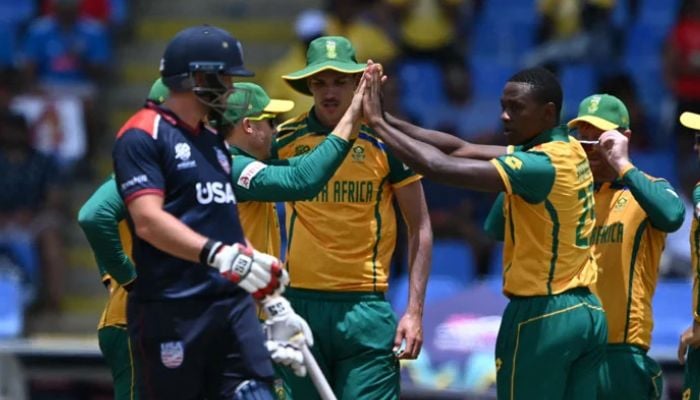 South Africas players celebrate after taking a wicket against the USA. — AFP