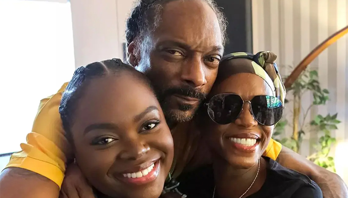 Snoop Dogg held his wife and daughter close to his chest for the birthday pictures