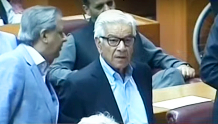 Federal Minister for Law Azam Nazeer Tarar (left) speaks to Defence Minister Khawaja Asif during National Assembly session on June 23, 2024. — Screengrab/YouTube/GeoNews