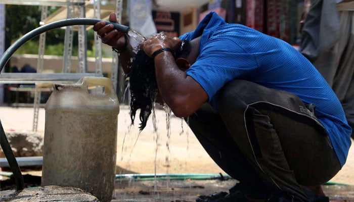 A man washes his head to cool himself during a hot day in Hyderabad on Sunday, June 2, 2024. — PPI
