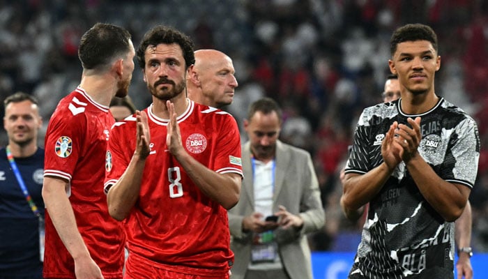 Denmarks midfielder #08 Thomas Delaney (L) and Denmarks defender #18 Alexander Bah react after a draw in the UEFA Euro 2024 Group C football match between Denmark and Serbia at the Munich Football Arena in Munich on June 25. — AFP