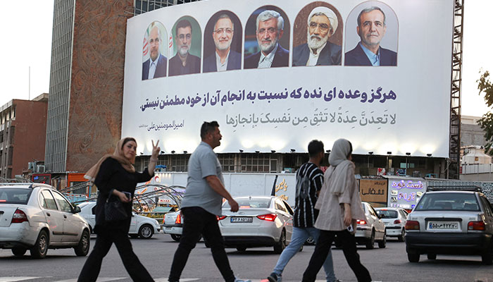 A billboard with a picture of the presidential candidates is displayed on a street in Tehran, Iran, June 17, 2024. — Reuters