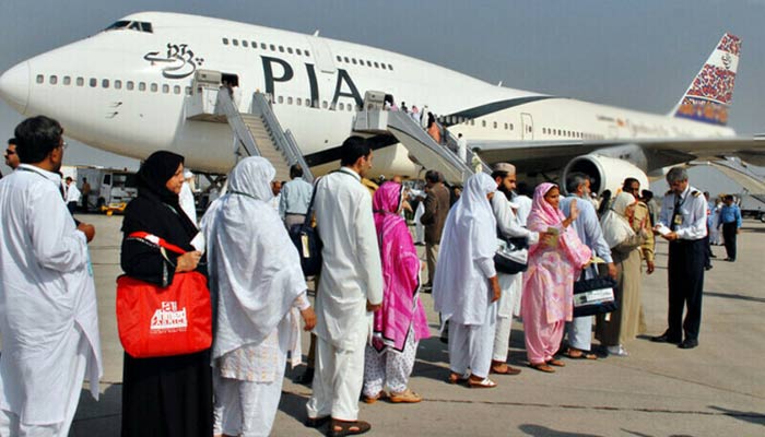 Pakistani pilgrims walk in line as they prepare to board PIAs special Hajj flight. — AFP/file