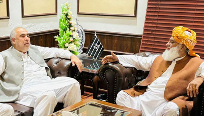 Pakistan Tehreek-e-Insaf leader Asaq Qasier (left) meets Jamiat Ulema-e-Islam-Fazl (JUI-F) Chief Maulana Fazlur Rehman in Islamabad on June 22, 2024. — Geo News/Waqar Satti