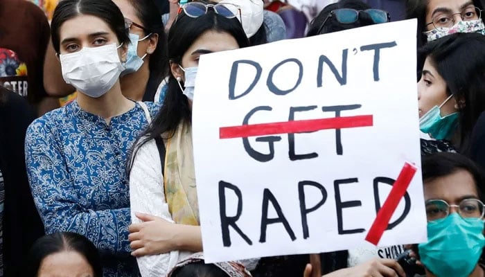 People carry signs against a gang rape that occurred along a highway and to condemn violence against women and girls, during a protest in Karachi September 12, 2020. — Reuters