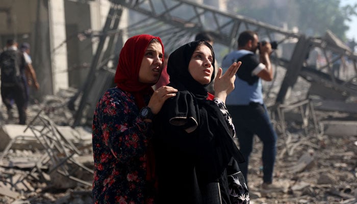 Palestinians women react as they look at the badly damaged Latin Patriarchate Holy Family School after it was hit during Israeli military bombardment, in Gaza City on July 7, 2024. — Reuters