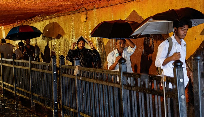 People walk in a waterlogged subway after heavy rains in Mumbai, India, July 8, 2024. — Reuters