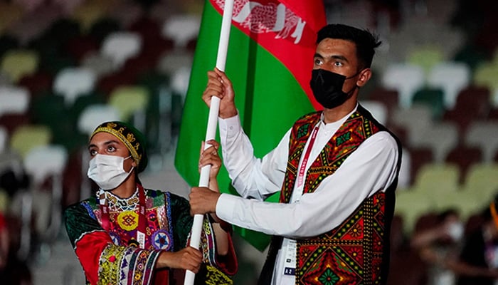 Farzad Mansouri and Kimia Yousofi of Afghanistan lead a contingent during the athletes parade at the opening ceremony of the Tokyo 2020 Olympic Games. — Reuters/File