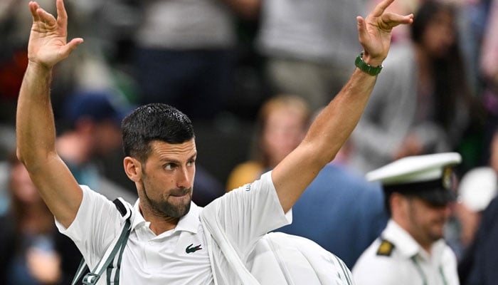 Winner Serbia’s Novak Djokovic waves to the crowd as he leaves Centre Court following his victory against Denmark’s Holger Rune during their men’s singles tennis match on the eighth day of the 2024 Wimbledon Championships at The All England Lawn Tennis and Croquet Club in Wimbledon, southwest London, on July 8, 2024.  —AFP