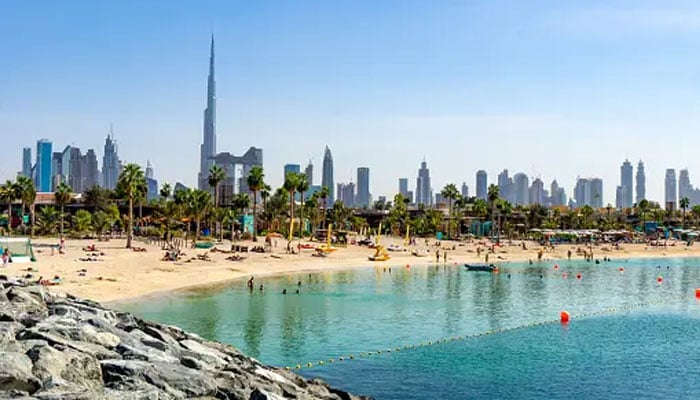 This image shows a people at a beach in Dubai, United Arab Emirates. — Unsplash