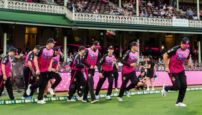 Members of the Sydney Sixers can be seen stepping onto a field in this undated image. — X/@SixersBBL