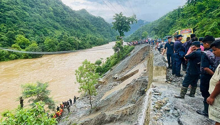 Rescuers search for survivors in the river Trishuli after a landslide swept two buses away on July 12, 2024. — AFP