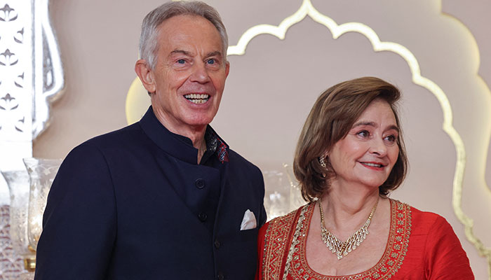 Former British Prime Minister Tony Blair and his wife Cherie Blair pose for pictures on the red carpet on the day of the wedding of Anant Ambani and Radhika Merchant in Mumbai, India, July 12, 2024. — Reuters