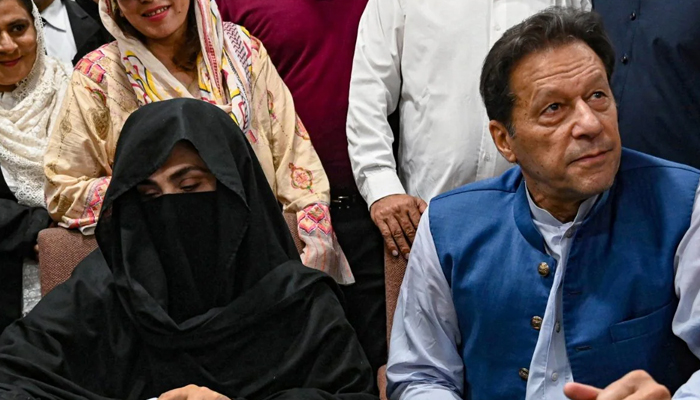 PTI founder Imran Khan (right) and his wife Bushra Bibi (left). — AFP