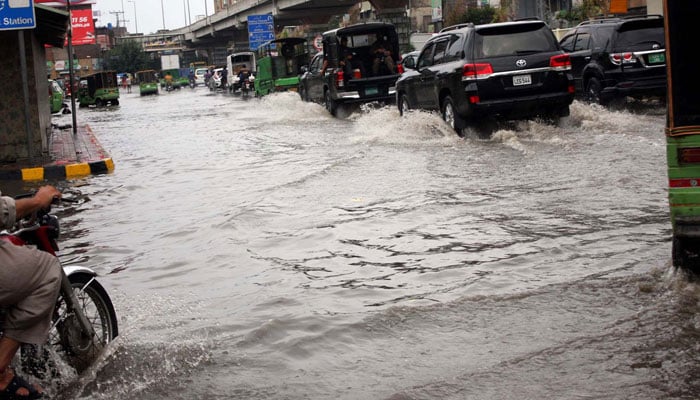 Commuters are facing difficulties in transportation due to stagnant rainwater due to poor sewerage system caused by heavy downpour of monsoon season, at Lytton road in Lahore on Friday, July 12, 2024. — PPI