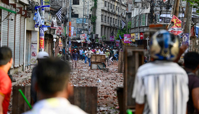 Anti-quota protesters and students backing the ruling Awami League party clash in Dhaka on July 16, 2024. — AFP