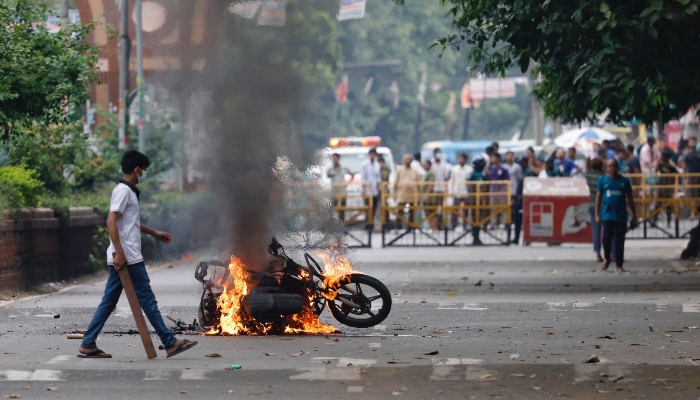 A motorcycle is set on fire at the campus of University of Dhaka, in Dhaka, Bangladesh, on July 17, 2024. —Reuters