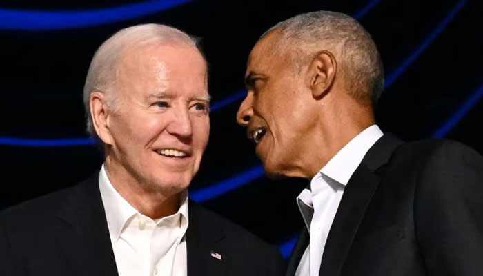 In this undated photo, US President Joe Biden (L) and Barack Obama are discussing a matter during an event. — AFP