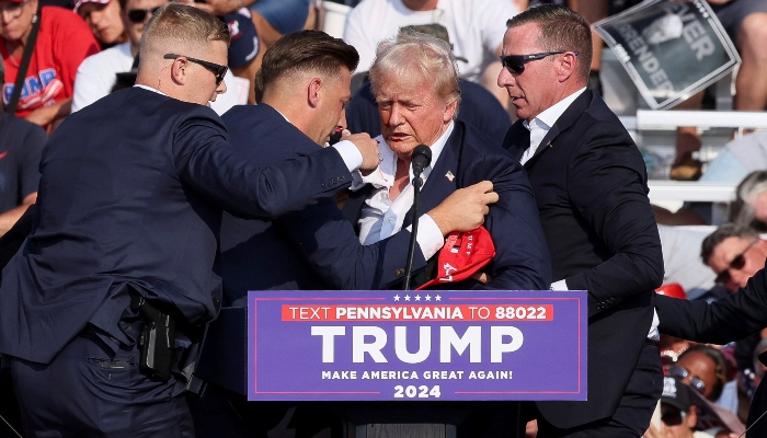 Republican presidential candidate and former US President Donald Trump is being covered by the Secret Service after multiple shots rang out during a campaign rally at the Butler Farm Show in Butler, Pennsylvania, US, July 13, 2024. — Reuters