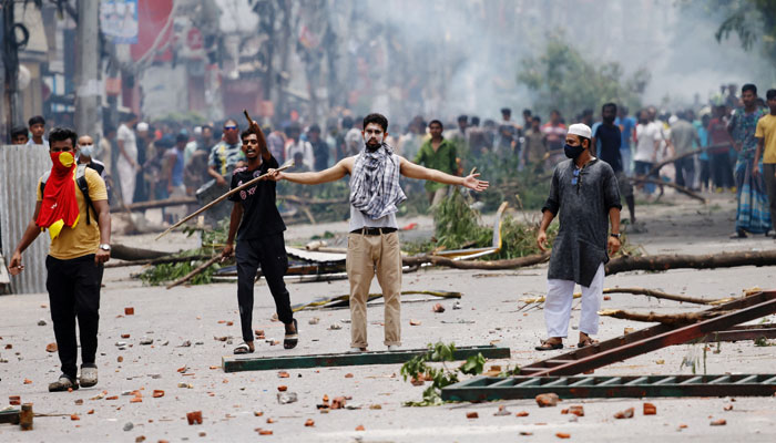 A demonstrator gestures as protesters clash with Border Guard Bangladesh (BGB) and the police outside the Bangladesh Television as violence erupts across the country after anti-quota protests by students, in Dhaka, Bangladesh, July 19, 2024. — Reuters