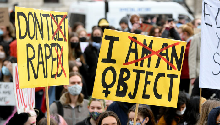 Demonstrators hold placards during a rally for womens rights and safety, following the murder of Sarah Everard, in Parliament Square, London, Britain, April 3, 2021. — Reuters