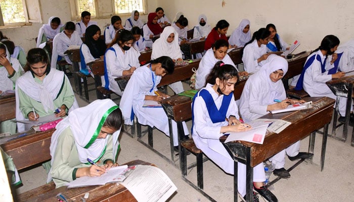 Students solving question paper during annual examination of HSSC (Part-I) 2024 at Degree Girls College at Latifabad in Hyderabad on June 5, 2024. — APP