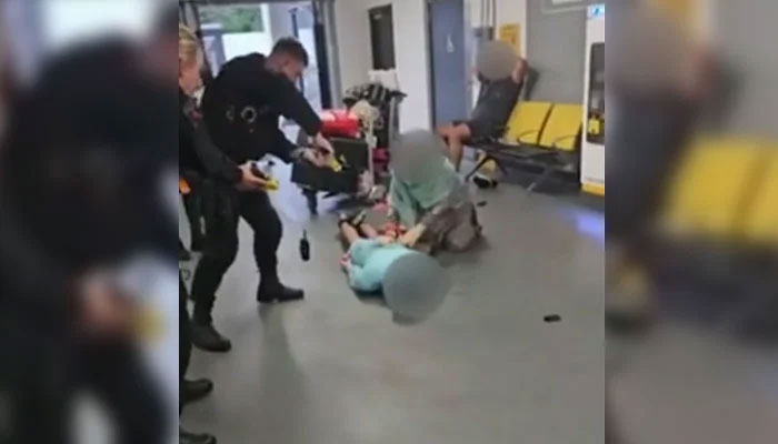 In this undated picture, a police officer is subjecting a man to torture at the Manchester Airport. — BBC/Screengrab