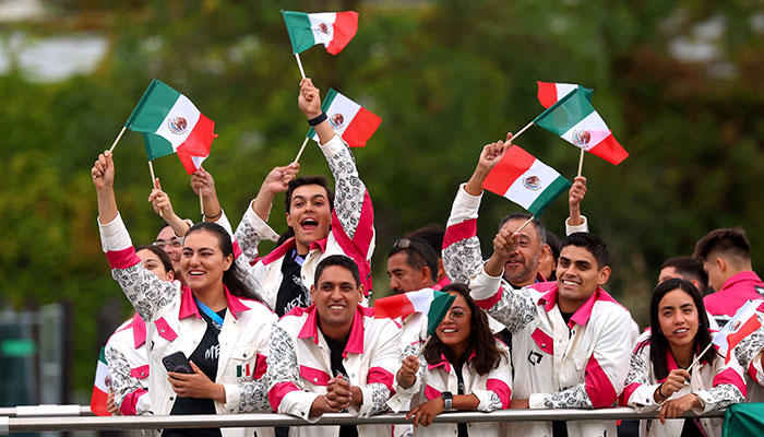 Athletes of Team Mexico wave handheld flags as they cruise during the athletes parade on the River Seine during the opening ceremony of the Olympic Games Paris 2024. — Reuters