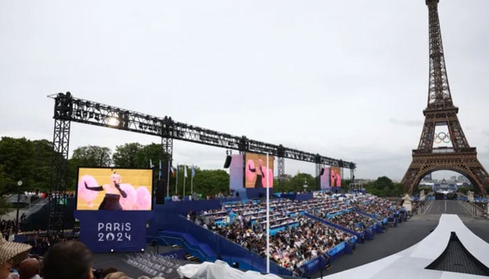 Wide shot of Lady Gaga performs during the opening ceremony with Eiffel Tower in background. — Reuters