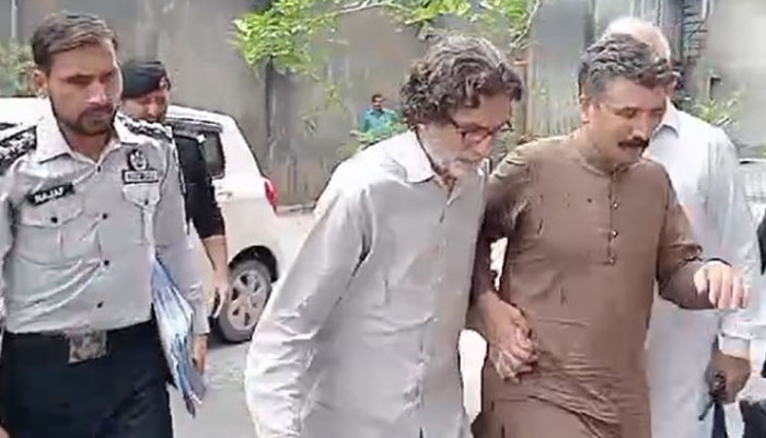 PTI Information Secretary Raoof Hasan walks as he is presented before a court for a hearing in Islamabad on July 28, 2024. — Geo News