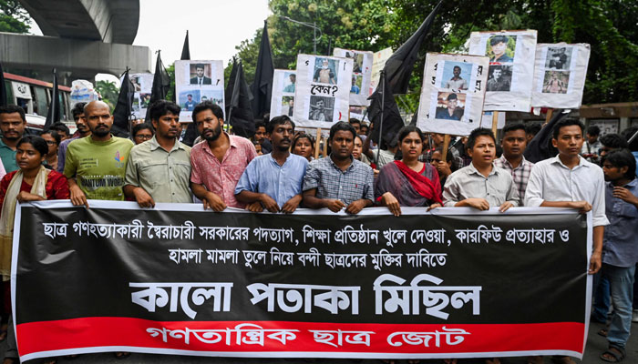 People take part in a protest march against the mass arrest and killing of protesters during last week´s violence amid anti-qouta protests, in Dhaka on July 28, 2024. — AFP