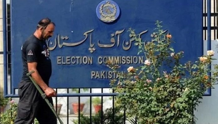 A guard and a signboard outside the Election Commission of Pakistan. — AFP/File