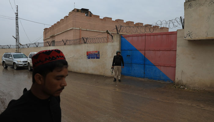 A police officer stands outside Achini’s outpost entrance gate in the outskirts of Peshawar, February 9, 2023. — Reuters