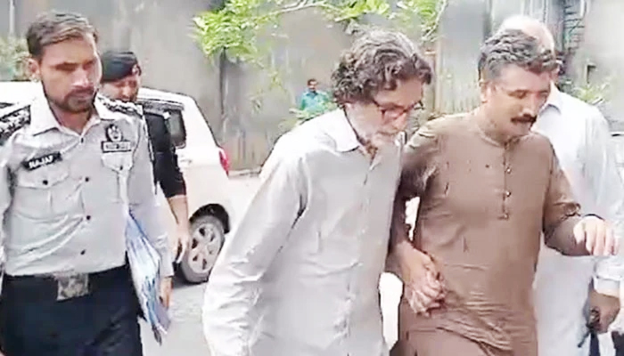 PTI Information Secretary Raoof Hasan walks as he is presented before a court for a hearing in Islamabad on July 28, 2024. — Geo News