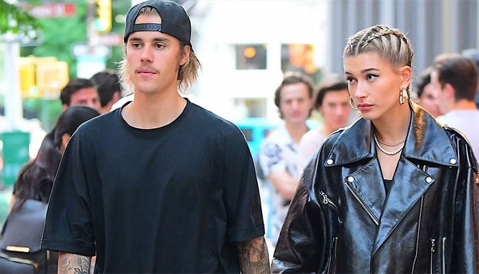 Justin Biebers slippers outshine Hailey during Beverly Hills theatre outing.