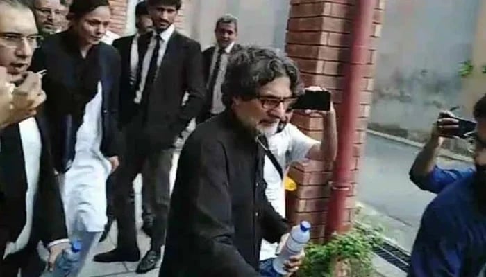 PTI Information Secretary Raoof Hasan walks as he is presented before a court for a hearing in Islamabad on July 23, 2024. — Geo News