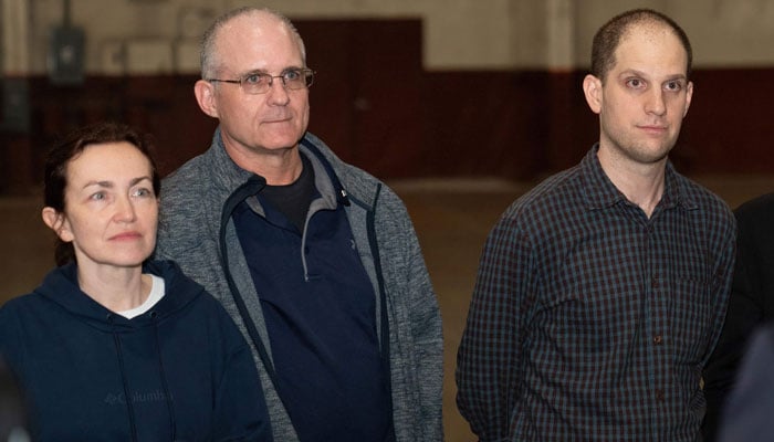 Former prisoners released by Russia, Evan Gershkovich (centre), ex-US marine Paul Whelan (right), and journalist Alsu Kurmasheva stand after landing at Joint Base San Antonio-Kelly Field, Texas, on August 2, 2024. — AFP