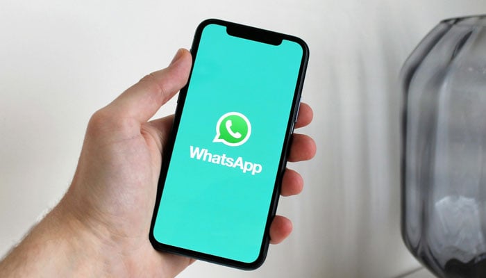 A representational image showing the WhatsApp logo displayed on a phone screen. — Pexels