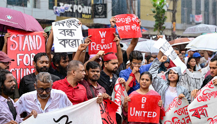 Protestors hold posters during a rally to demand justice for victims arrested and killed in the recent countrywide violence in Dhaka on August 1, 2024. — AFP