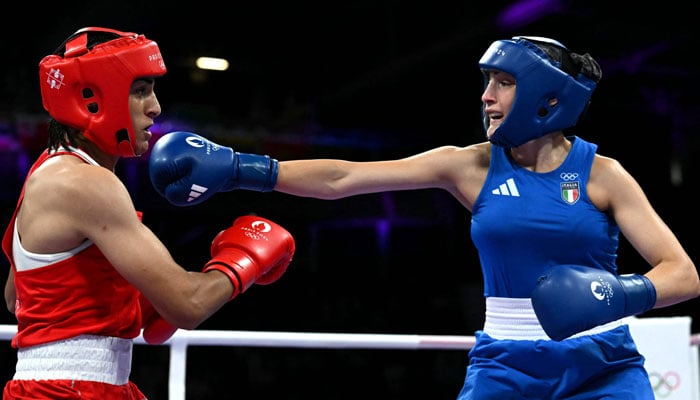 Algeria’s Imane Khelif (in red) takes a punch from Italy’s Angela Carini in the women’s 66kg preliminaries round of 16 boxing match during the Paris 2024 Olympic Games at the North Paris Arena, in Villepinte on August 1, 2024. — AFP