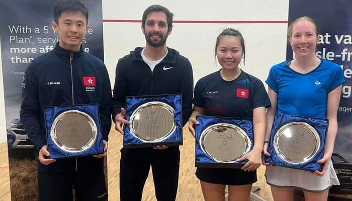 Pakistani squash player Nasir Iqbal (second left) poses with the Bega Open 2024 shield along with other players in Australia. — Reporter